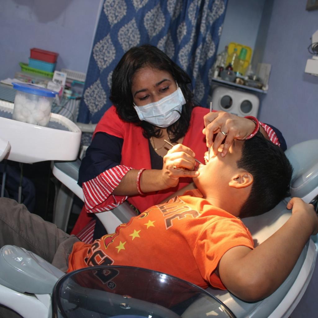 Dr. Mavia treating a patient at Shifa Dental Clinic